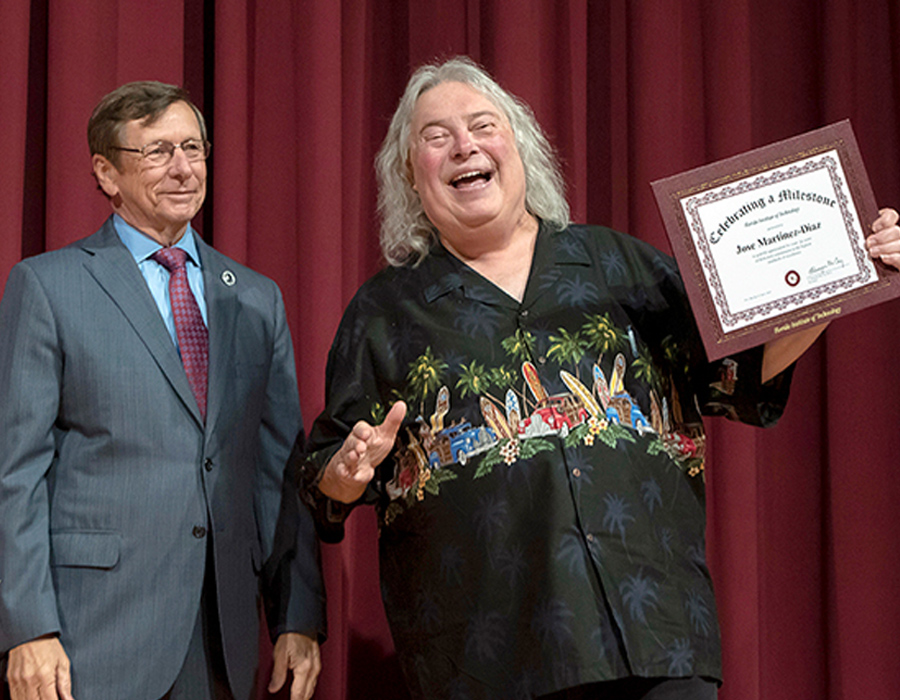 Jose receiving achievement award