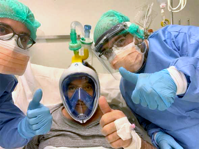 Guy with snorkel mask in hospital bed