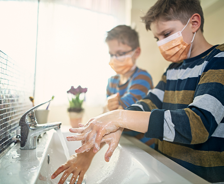 Children Washing Hands While Wearing Face Masks