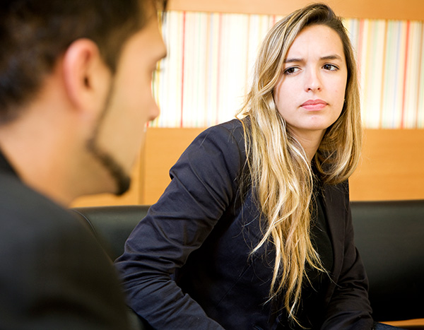 Woman looking intently at man