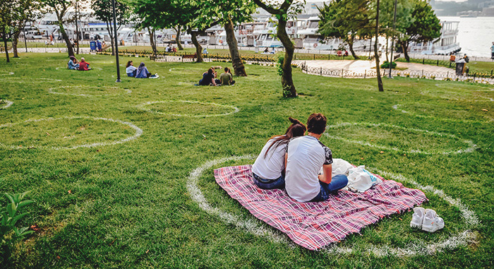 Couple sitting on lawn with designated circles drawn