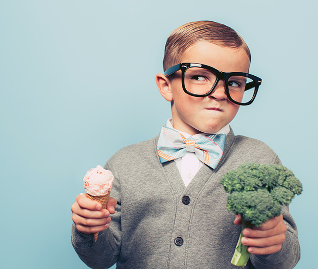 Boy with ice cream and broccoli