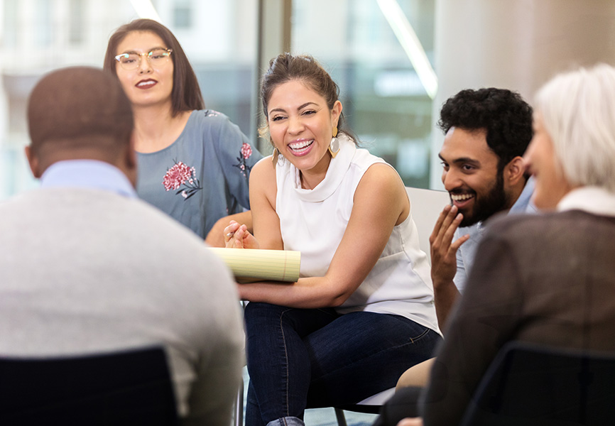 Five diverse business people having a meeting around a table