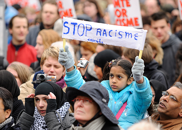 Girl holding up "Stop Racism" sign