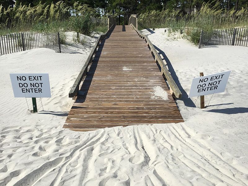 Beach access with no exit or entry signs