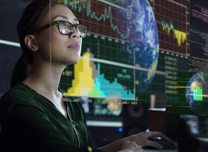 A scientist looking at the globe on a screen