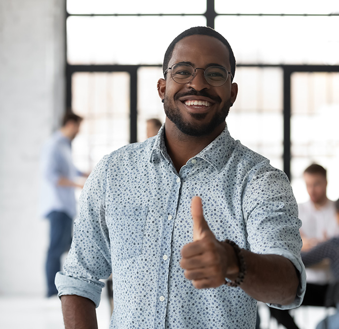 Smiling man giving a thumbs up