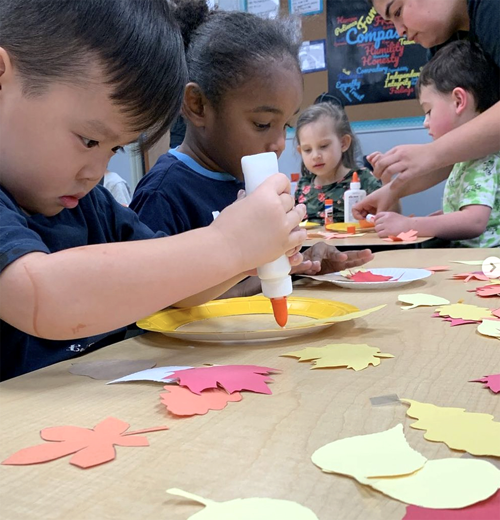 Autistic children creating a fall craft
