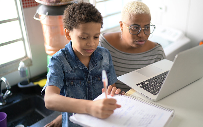 Woman with child in front of laptop