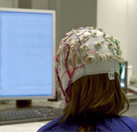 A Child with electrodes on their head for a brain scan