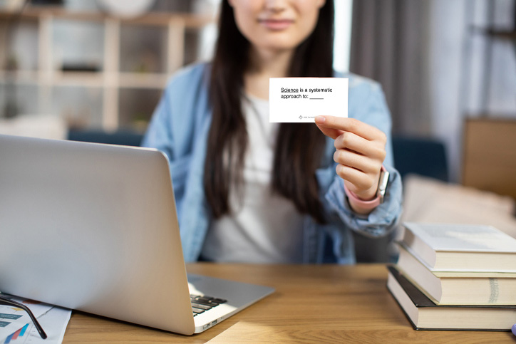 Person holding up a SAFMED flashcard