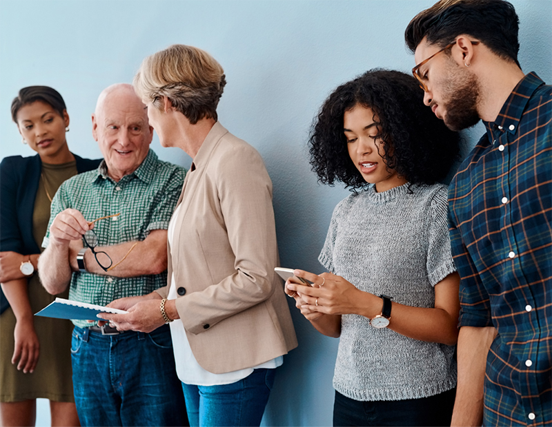 five people talking in a business setting