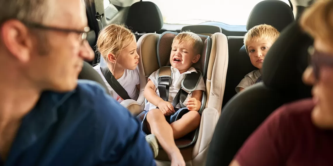 Parents with children misbehaving in the car