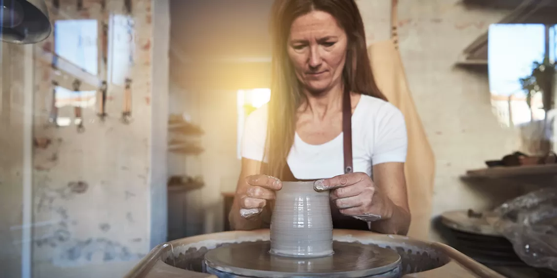 Woman Working at Ceramics and Pottery Wheel