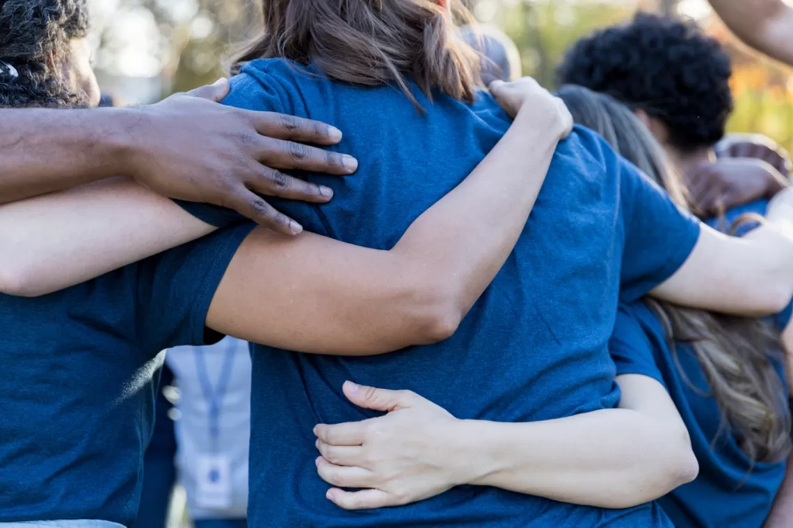 A diverse group of people in a huddle