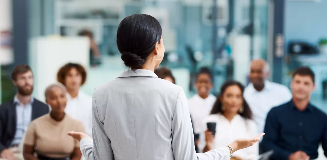 A woman presenting to a group of professionals 