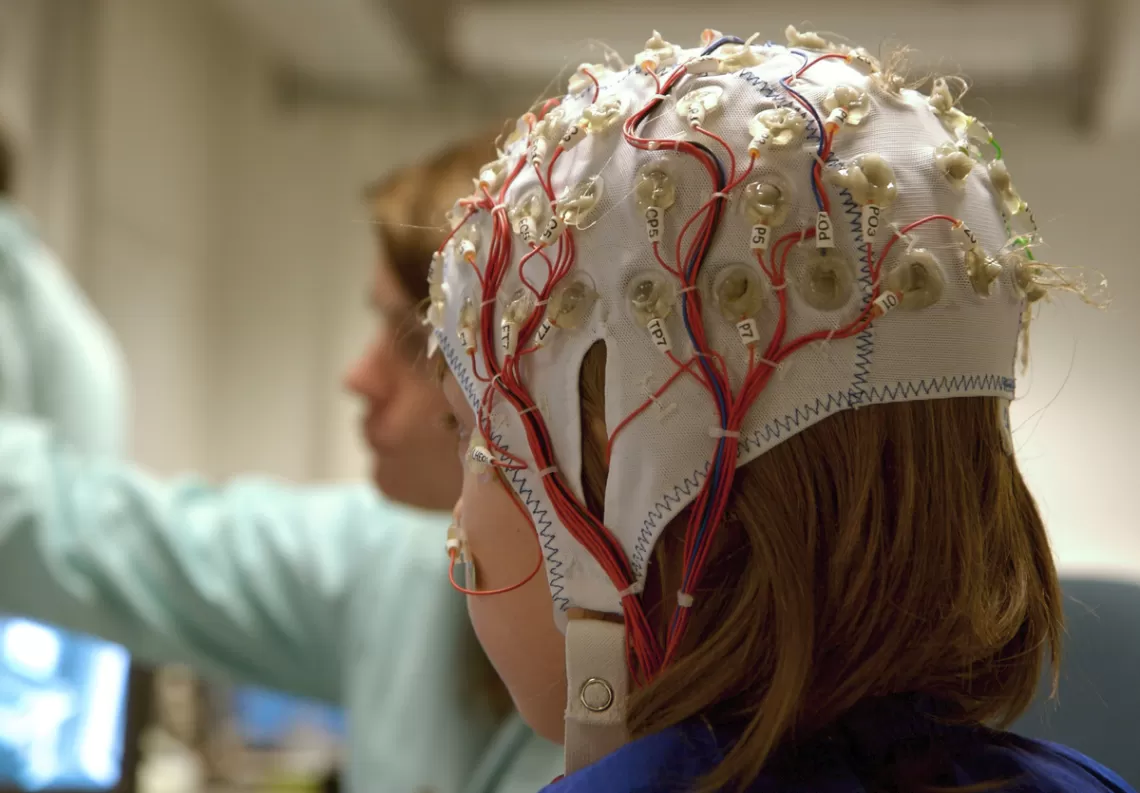A child with electrodes on their head for a brain scan