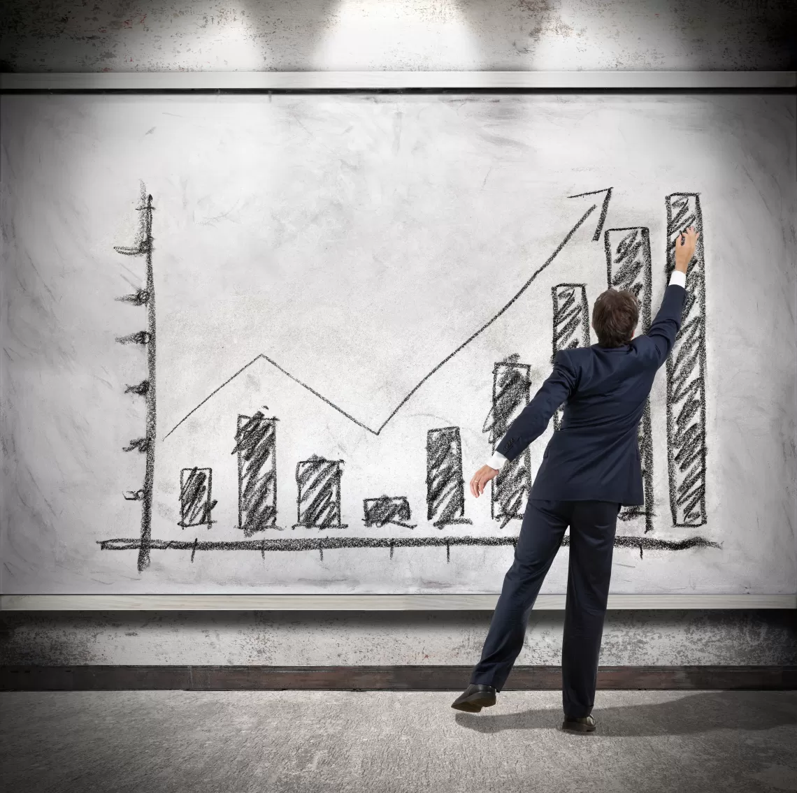 Man in suit in front of giant graph