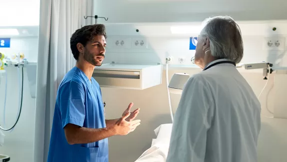 Nurse and doctor talking in hospital