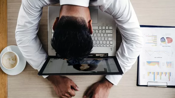 Stressed out man in front of laptop