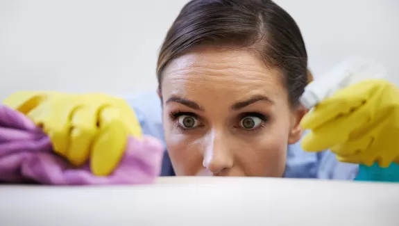 Woman Cleaning Looking Frantic