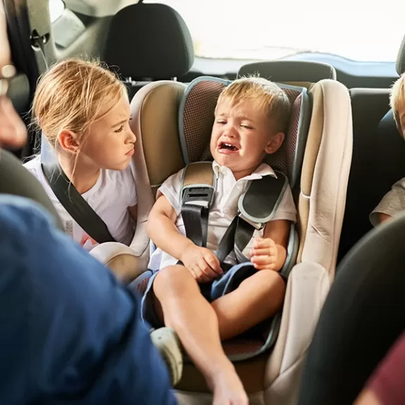 Parents with children misbehaving in the car
