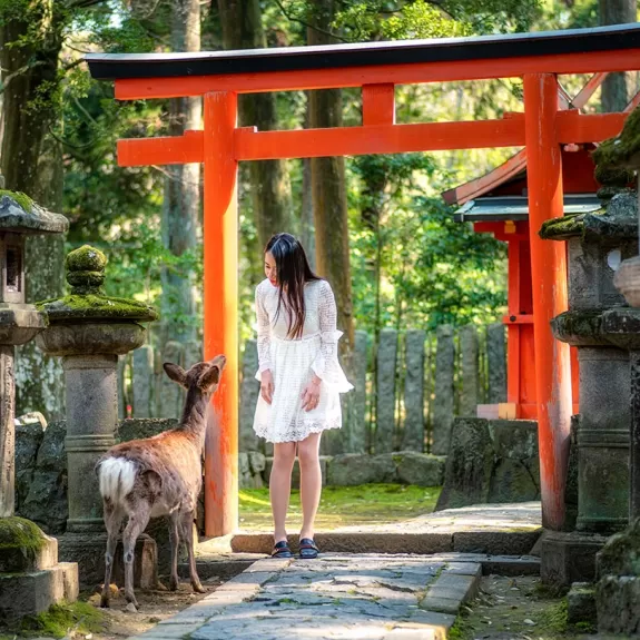 Girl with deer at temple
