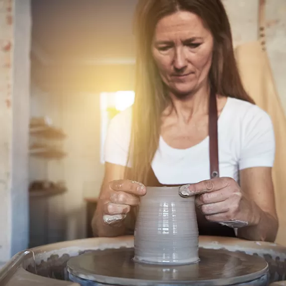 Woman Working at Ceramics and Pottery Wheel