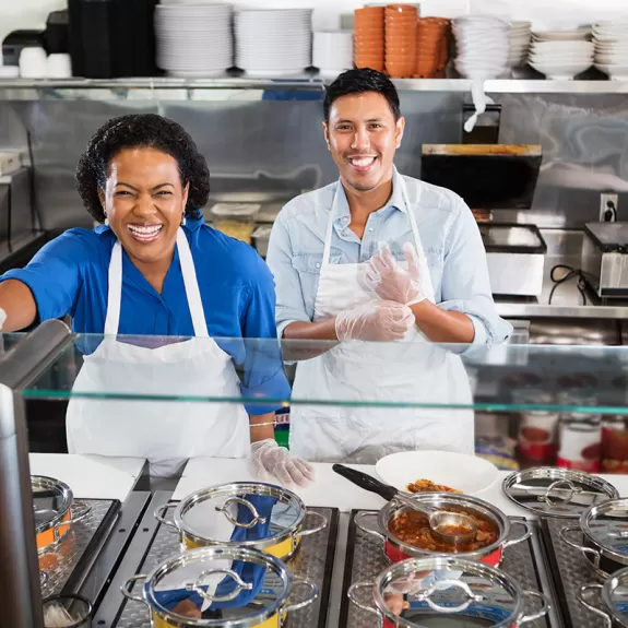 Leadership and Culture OBM series, two smiling people serving food