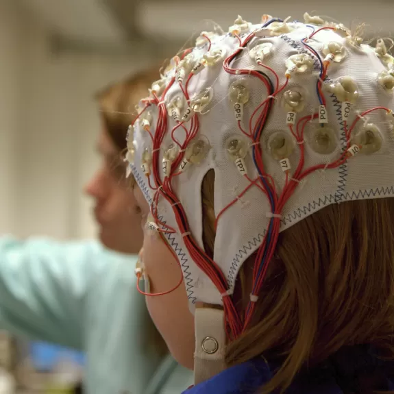 A child with electrodes on their head for a brain scan